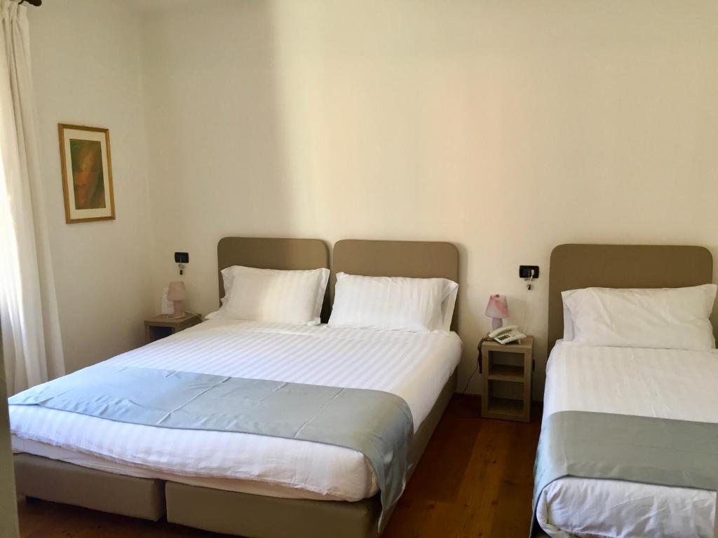 Postel nebo postele na pokoji v ubytování Albergo Isetta