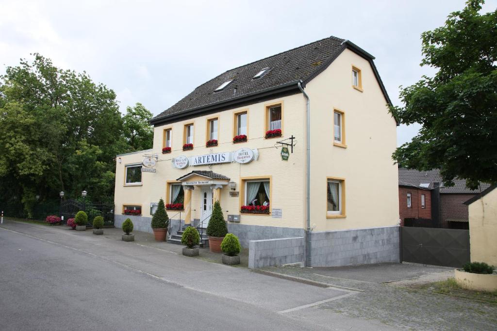 ein weißes Gebäude an der Straßenseite in der Unterkunft Hotel-Restaurant Artemis in Willich