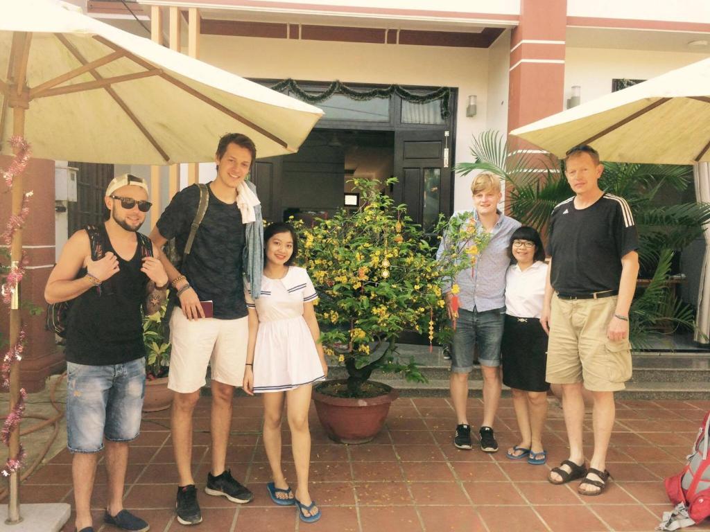 a group of people standing in front of a house at Countryside Garden Homestay in Hoi An