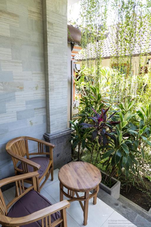 two chairs and a table on a porch at Sudiana House in Ubud