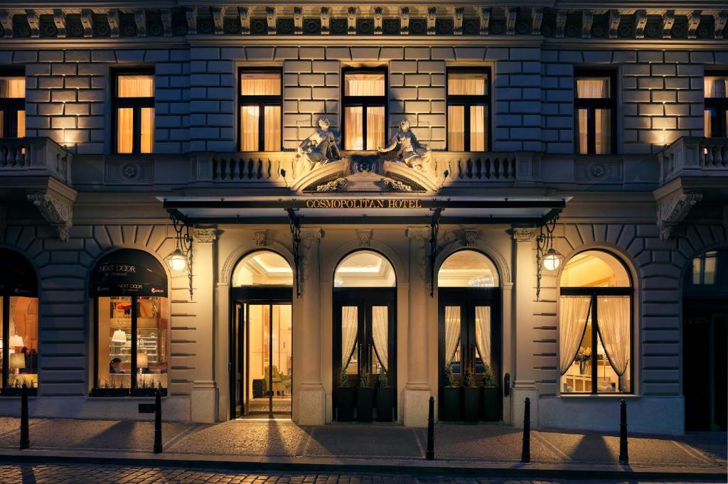 a facade of a building at night at COSMOPOLITAN Hotel Prague in Prague