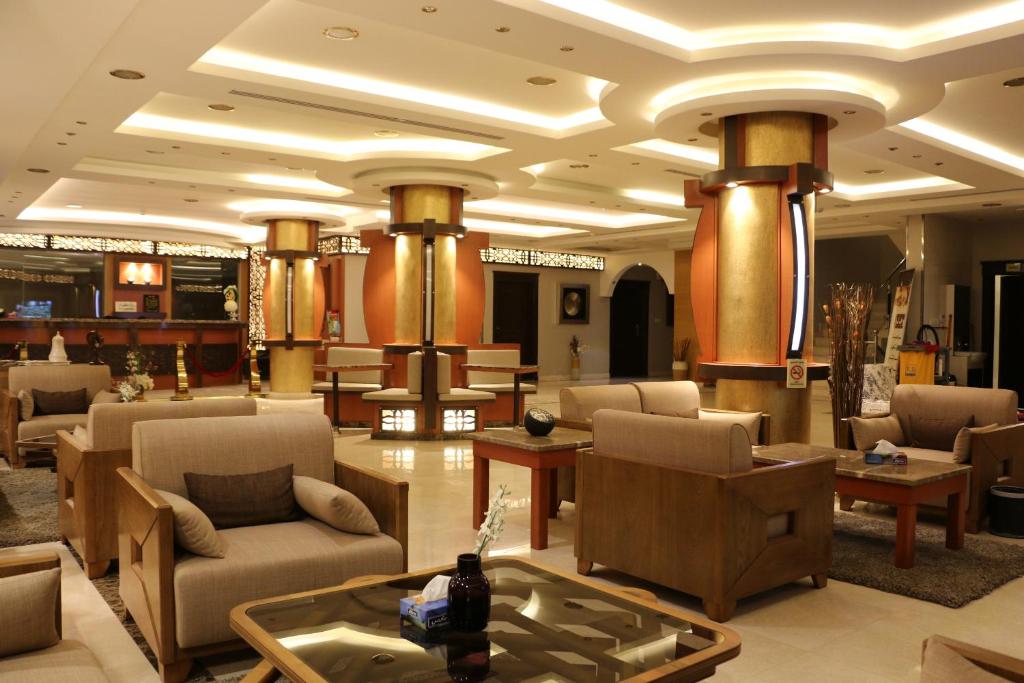 a lobby with couches and chairs in a building at Al Joon Aparthotel in Riyadh