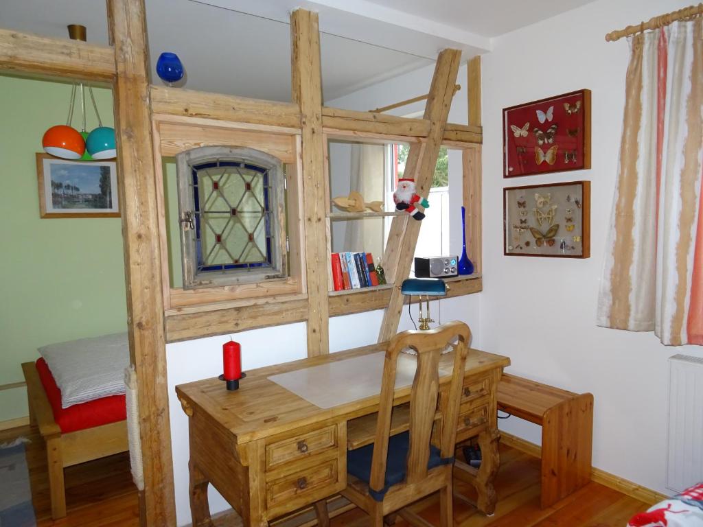 a room with a desk and a loft bed at "Zur Schmücke 69" in Ilmenau