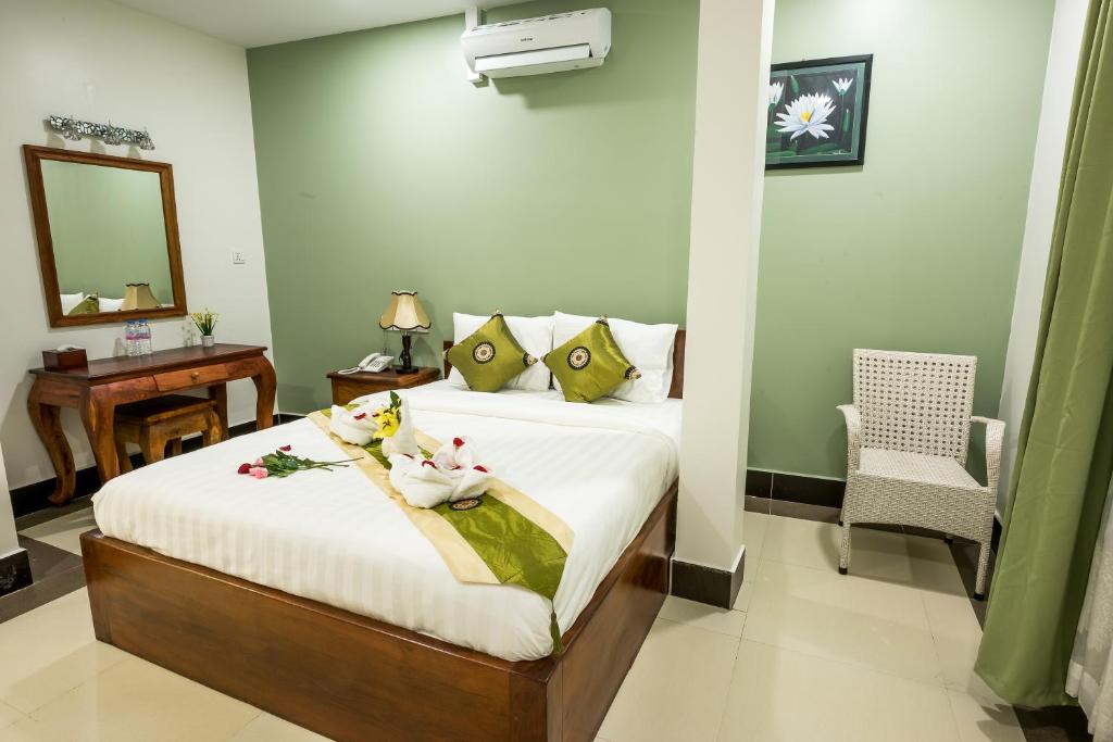 Postel nebo postele na pokoji v ubytování NKS Hotel