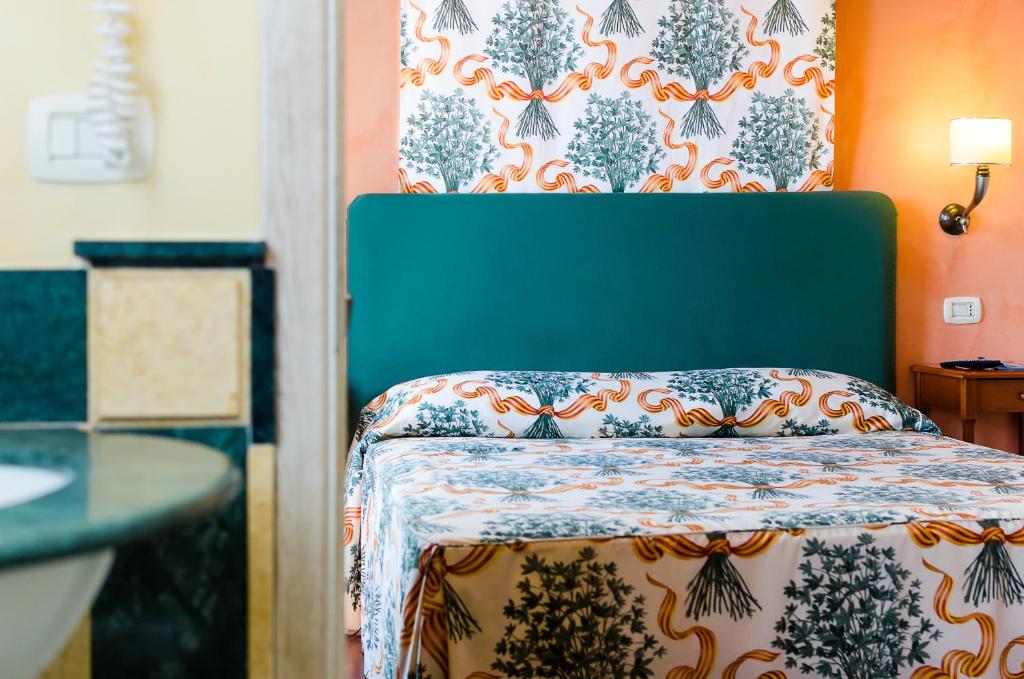 Postel nebo postele na pokoji v ubytování Hotel Vecchio Borgo