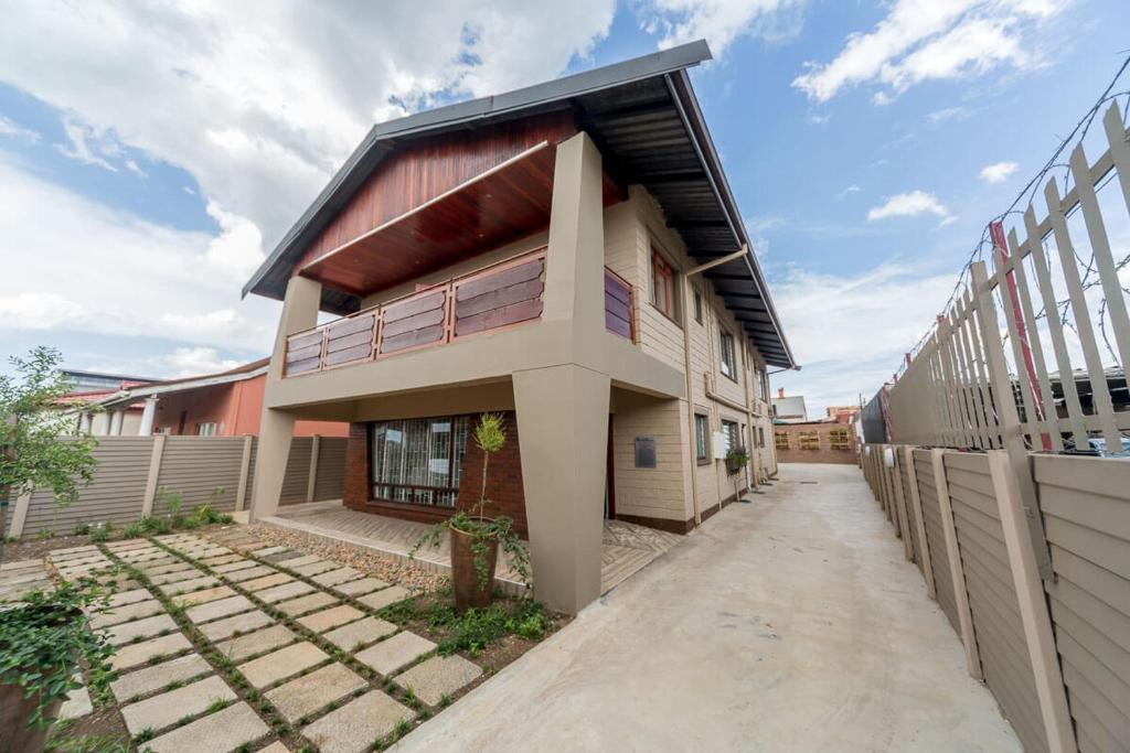 a building with a walkway in front of it at The Musafer Travel Lodge in Pietermaritzburg