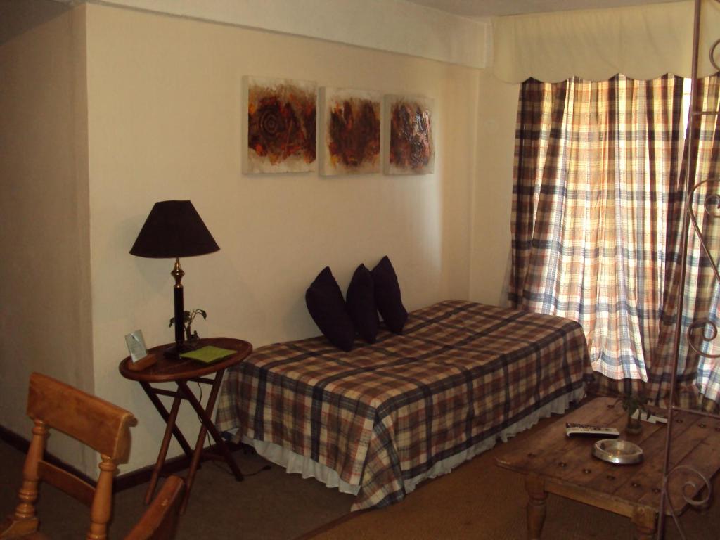 Postel nebo postele na pokoji v ubytování Apart Hotel Punto Real