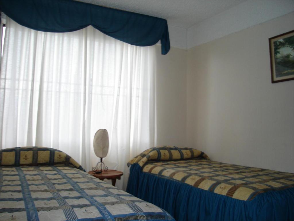 Postel nebo postele na pokoji v ubytování Apart Hotel Punto Real
