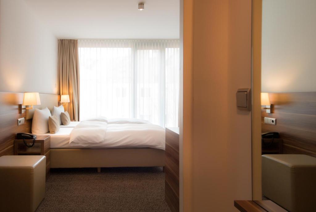 Postel nebo postele na pokoji v ubytování Downtown Vi Vadi Hotel