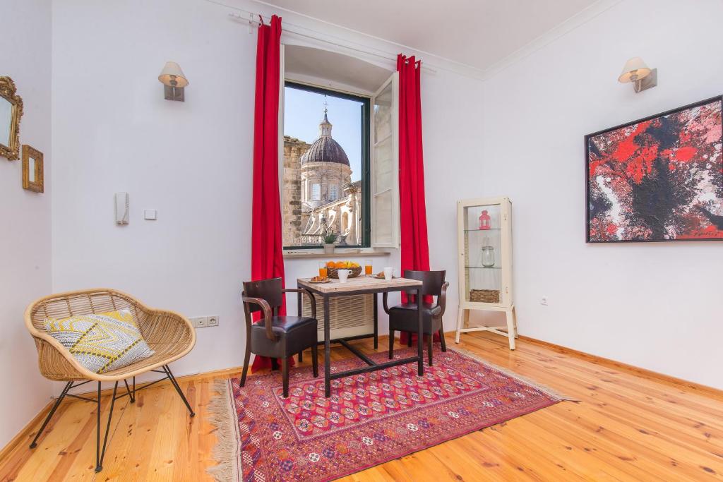 a living room filled with furniture and a table at Arty Old Town Apartments by Irundo in Dubrovnik