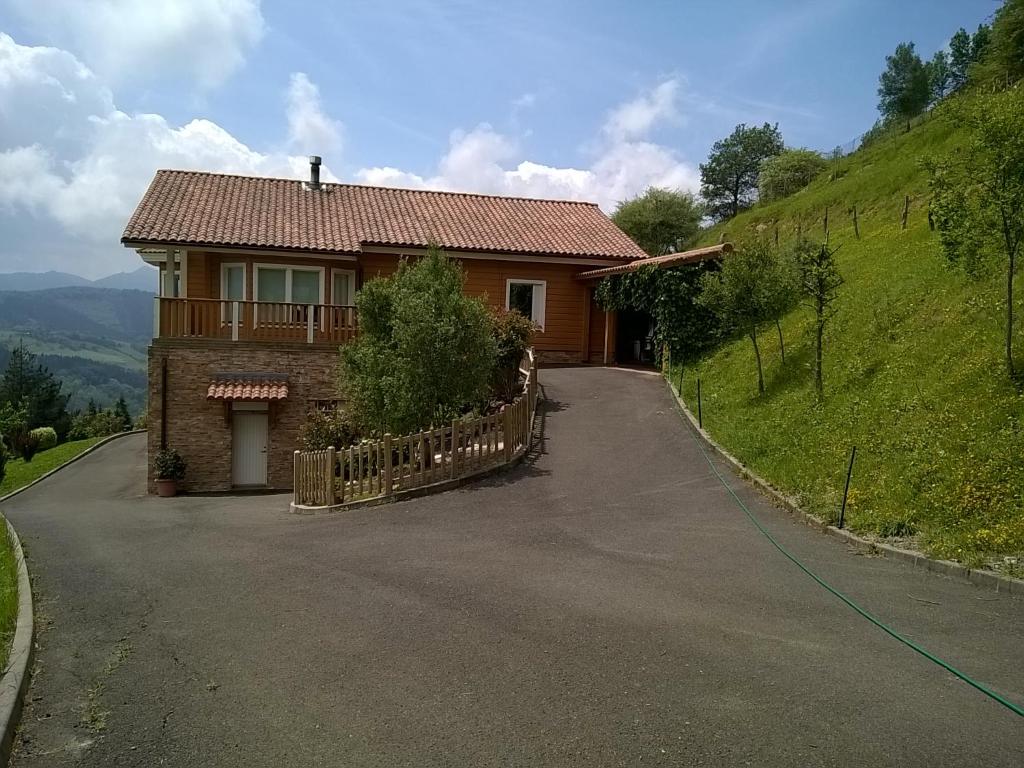 a house on the side of a hill with a driveway at Casa Rural Arbegain Etxea in Aizarna