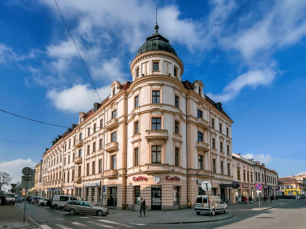 a large building with a dome on top of it at Hotel BAST Wellness & SPA in Inowrocław