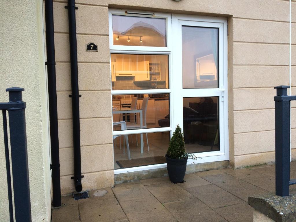 a window with a potted plant in front of it at Deluxe Seaside Apartment Ground Floor with Private Entrance and Patio in Bundoran