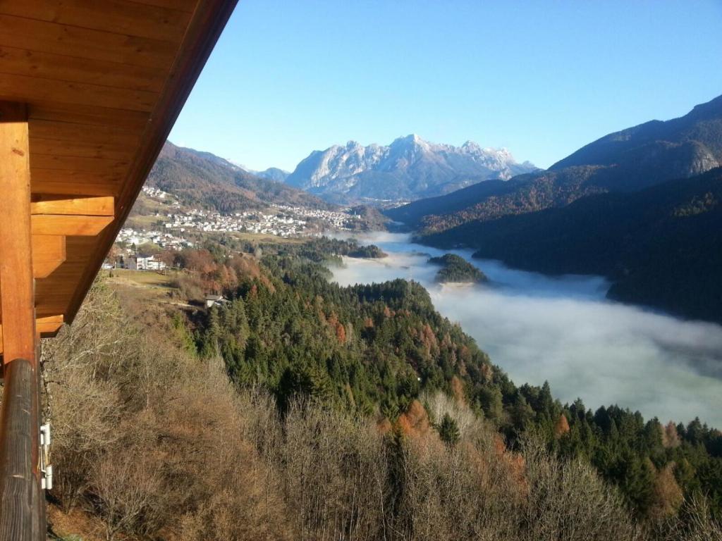 a view of a valley with a river and mountains at Dolomiti in Pieve di Cadore