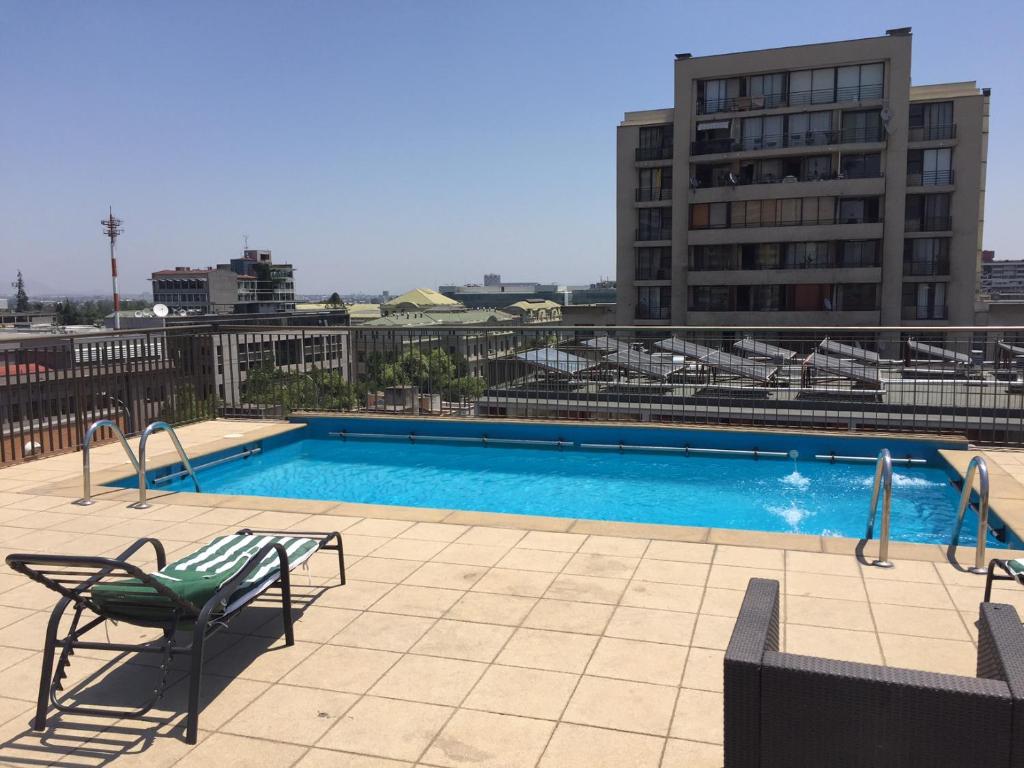 a swimming pool on top of a building at Departamento Vergara in Santiago