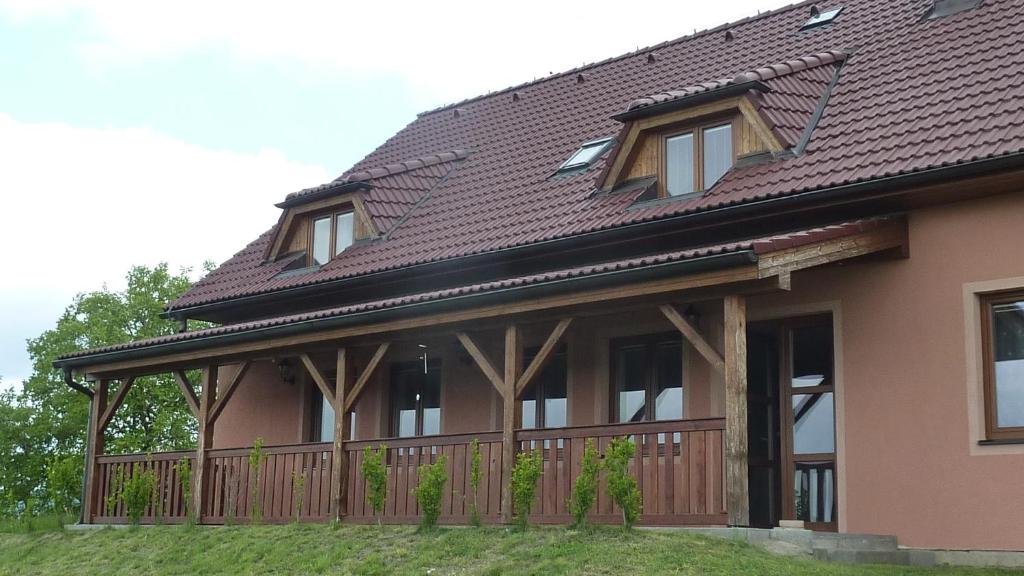 a house with a deck and a roof at Penzion Slávka in Třemošnice