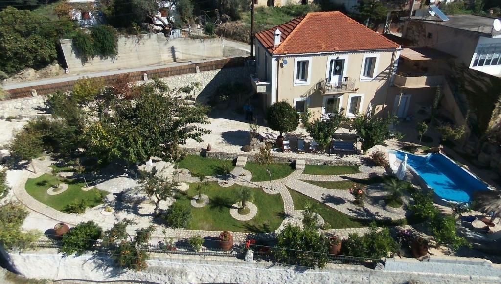 an aerial view of a house with a garden at Villa Petra with heated pool in Kalochorafitis