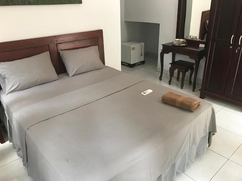 Postel nebo postele na pokoji v ubytování Santana Bali Home stay