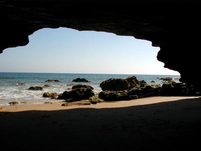 a view of the ocean from a cave on a beach at Hostal Mar de Frente in Los Caños de Meca