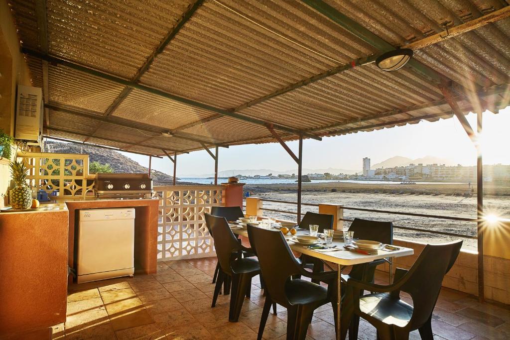 a restaurant with a table and chairs and a view of the train at El Gachero in Puerto de Mazarrón