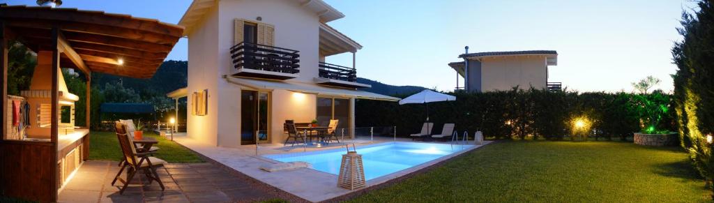 a house with a swimming pool in the yard at Casa Smaragdi Villas in Lefkada