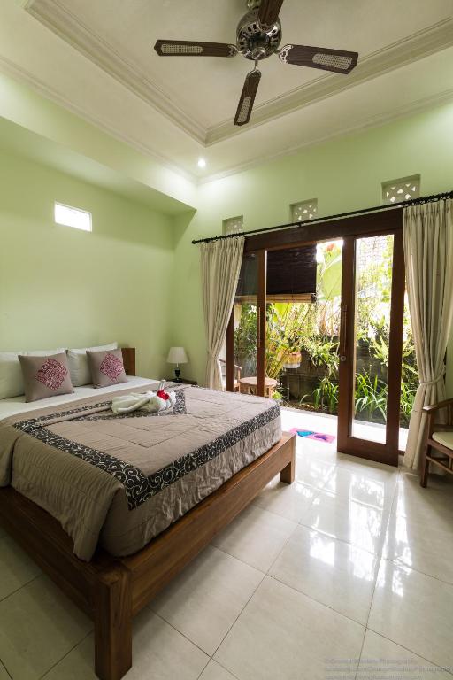 a bedroom with a large bed in a room at Sudiana House in Ubud