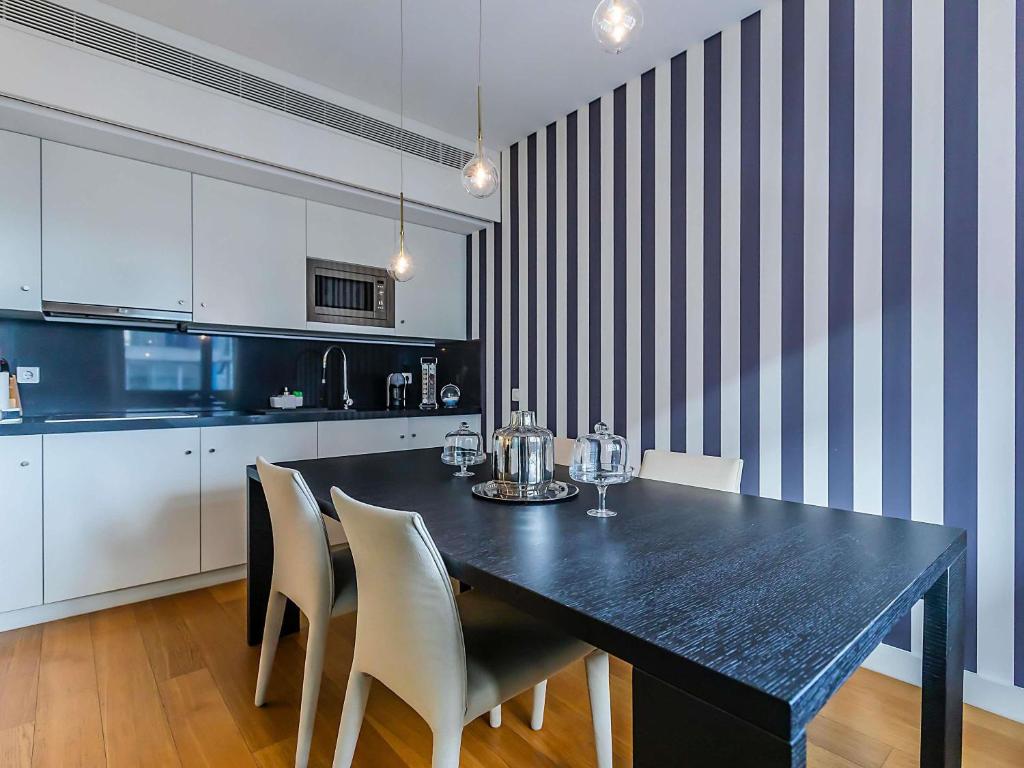A full kitchen and dining area with a large black table.