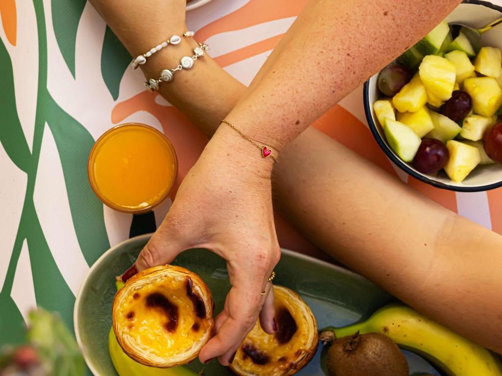 A close breakfast spread featuring pastries, fruit and orange juice.