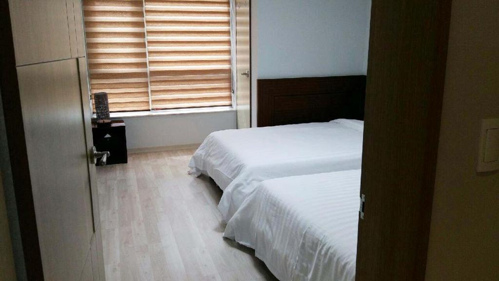 Postel nebo postele na pokoji v ubytování Gaon Residence Hotel