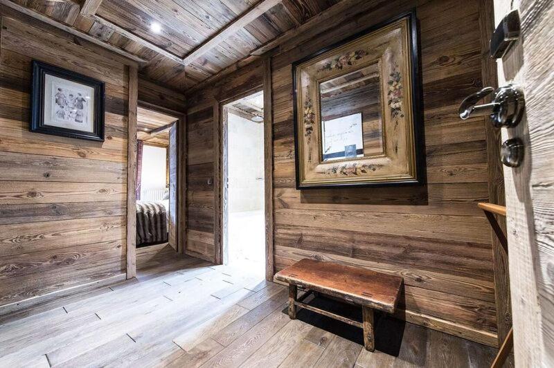 a room with a wooden wall with a bench in it at Le Chalet Blanc in Megève