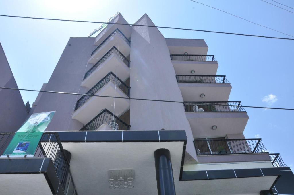 a tall building with balconies on the side of it at Kersay Hotel in Addis Ababa