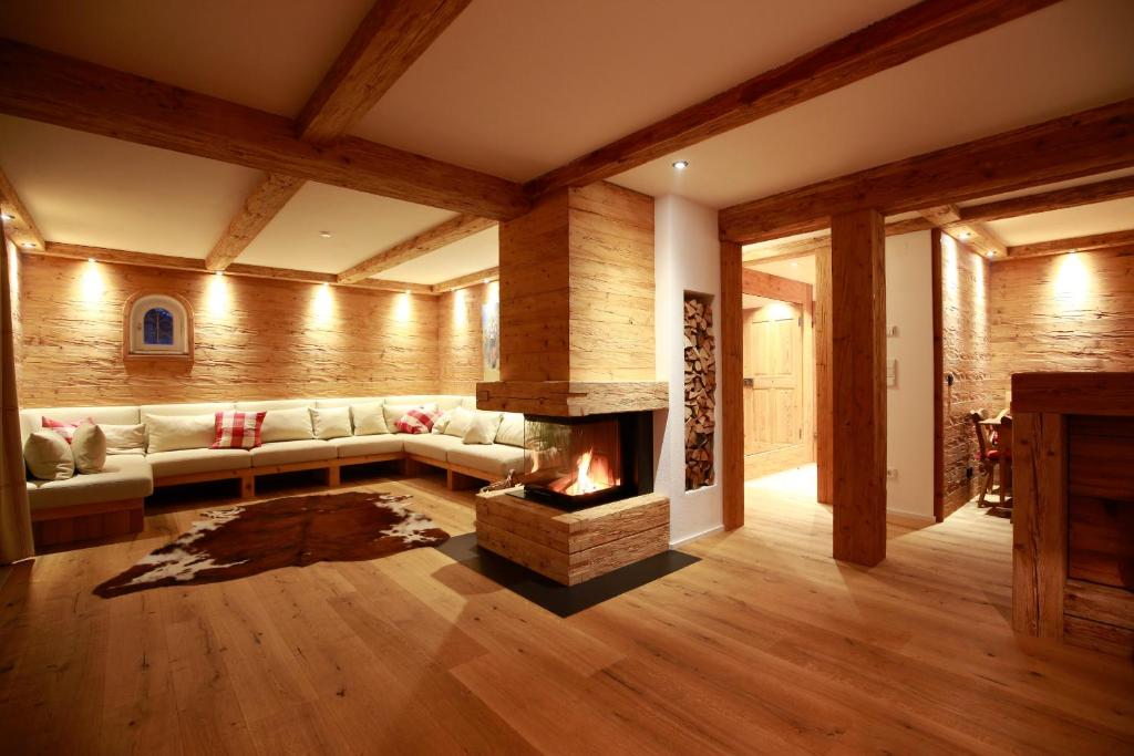 a living room with a couch and a fireplace at Haus Iris in Oberstdorf