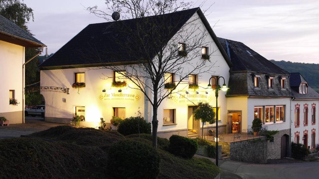 a large white building with a black roof at Hotel "Zur Moselterrasse" in Palzem