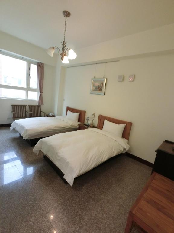 Postel nebo postele na pokoji v ubytování Long Zhi Yue Hotel