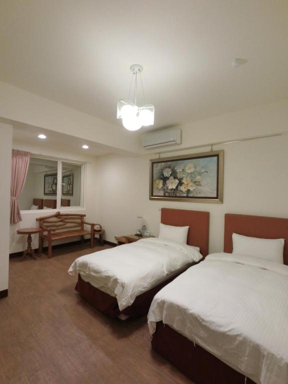 Postel nebo postele na pokoji v ubytování Long Zhi Yue Hotel