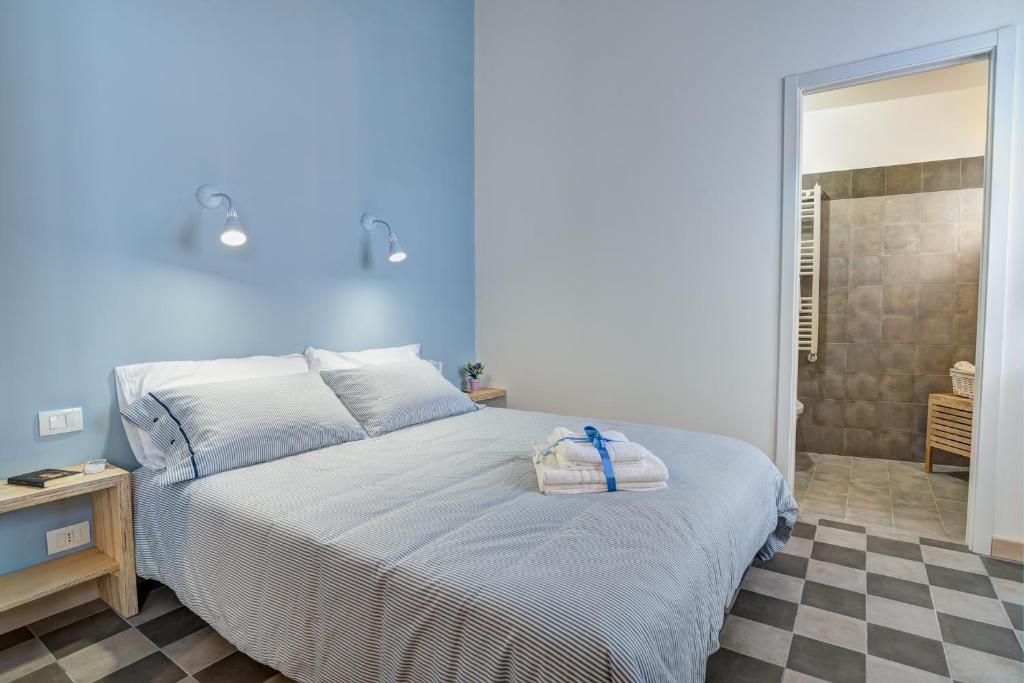 a blue bedroom with a bed with a bag on it at B&B Vico Manenti in Modica