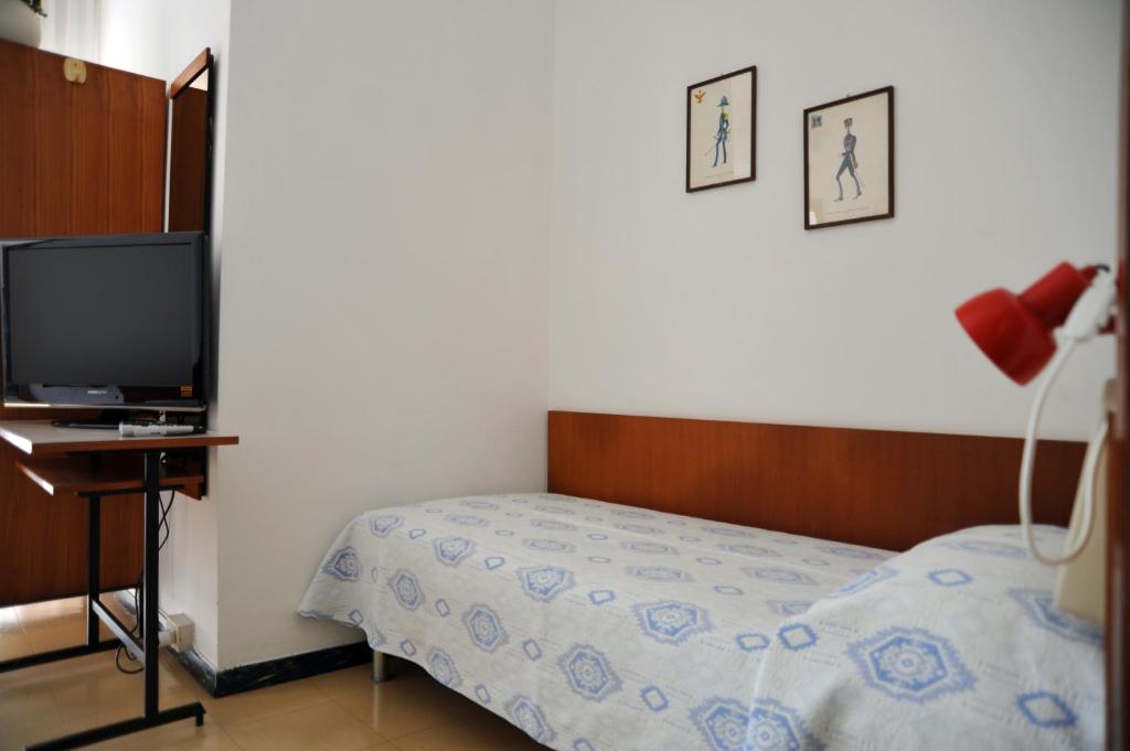 Postel nebo postele na pokoji v ubytování Hotel Reno