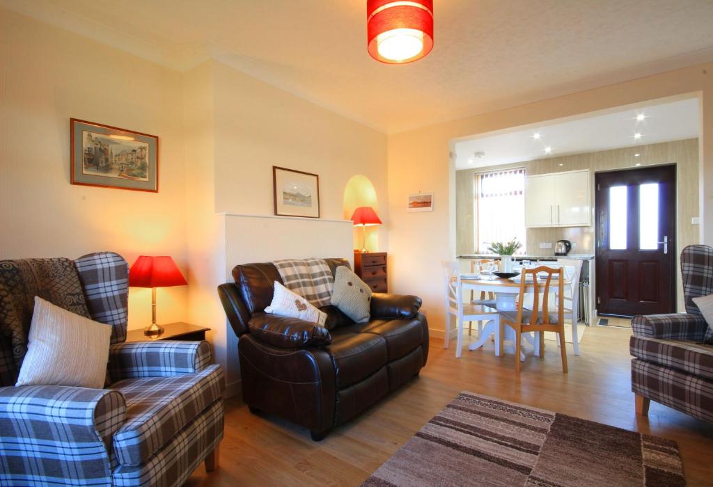 sala de estar con sofá y mesa en Sheneval Apartment en Inverness