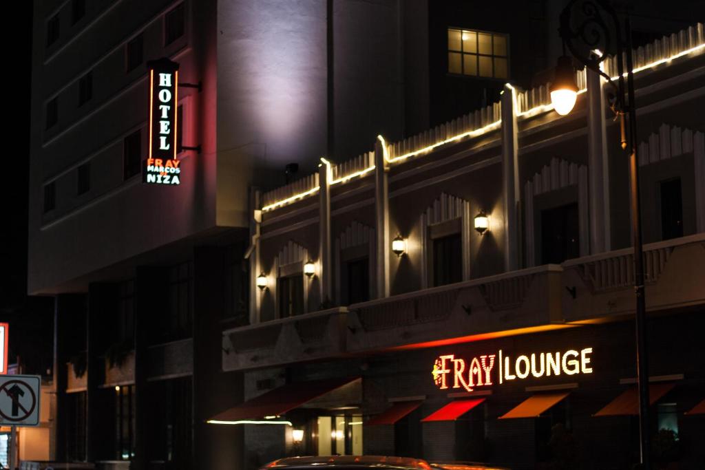 a tall building with a sign for a hotel at Hotel Fray Marcos in Nogales