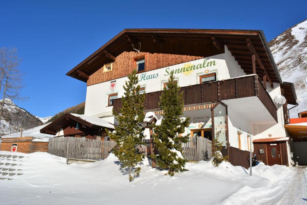 a hotel in the mountains with snow on the ground at Haus Sonnenalm in Sankt Sigmund im Sellrain