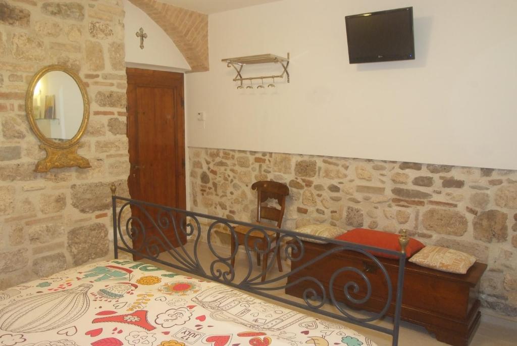 a bedroom with a bed and a tv on a wall at Piccola corte in Ascoli Piceno