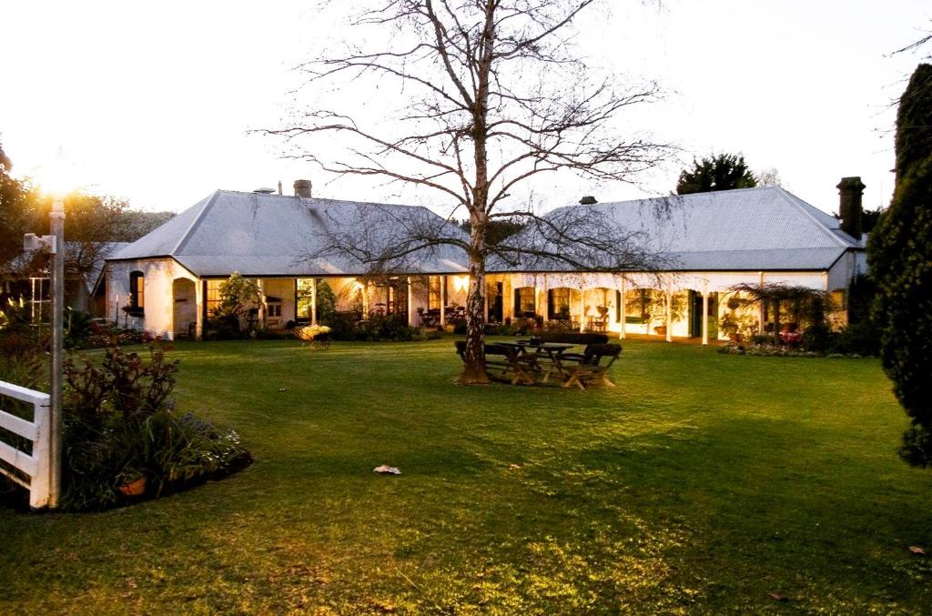 a house with a tree in the yard at Dingup House in Manjimup