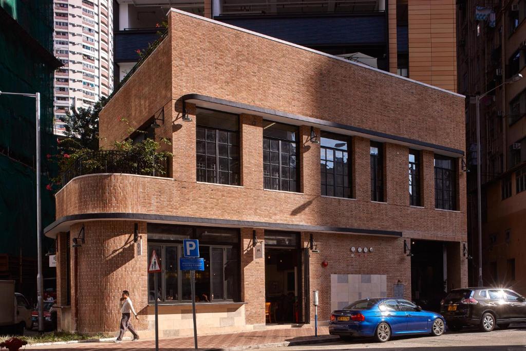 a brick building on the corner of a city street at Little Tai Hang in Hong Kong