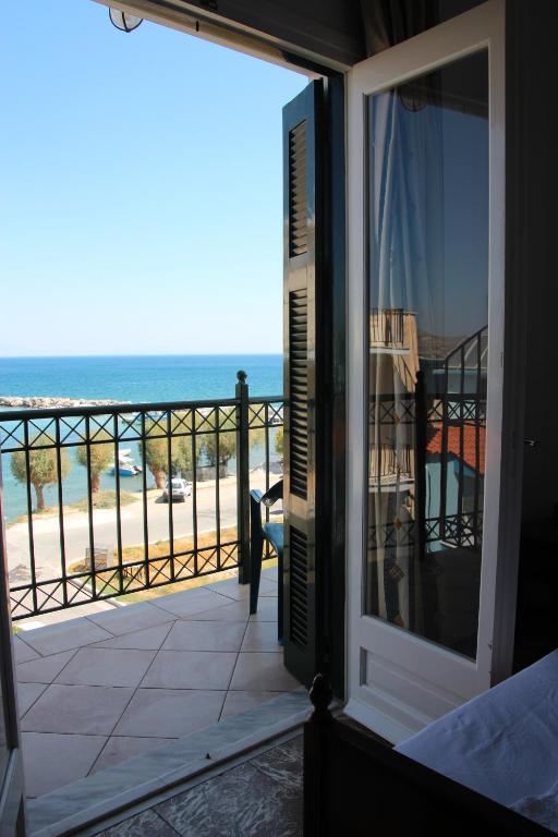 a room with a view of the beach from a balcony at Cohyli Hotel in Ireon