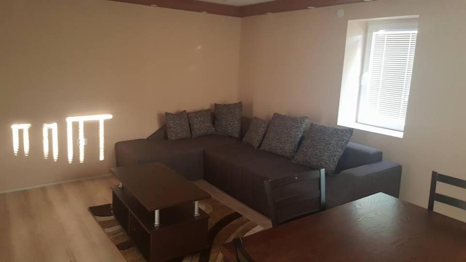 a living room with a couch and a table at Pestani Apartment in Peštani