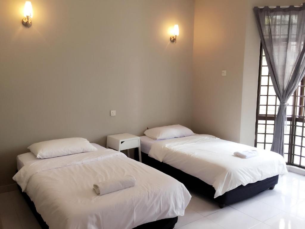 Postel nebo postele na pokoji v ubytování Homestay Muar