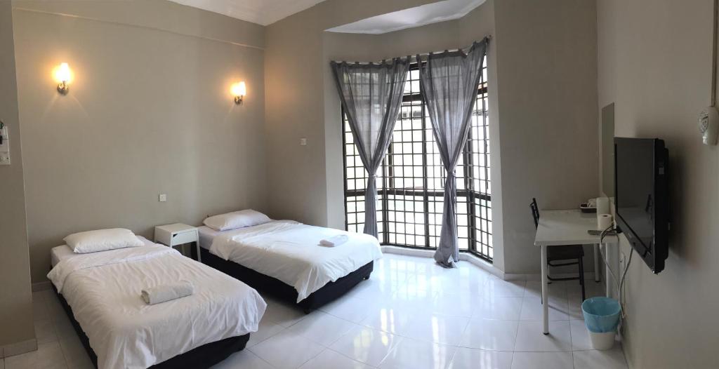 Postel nebo postele na pokoji v ubytování Homestay Muar