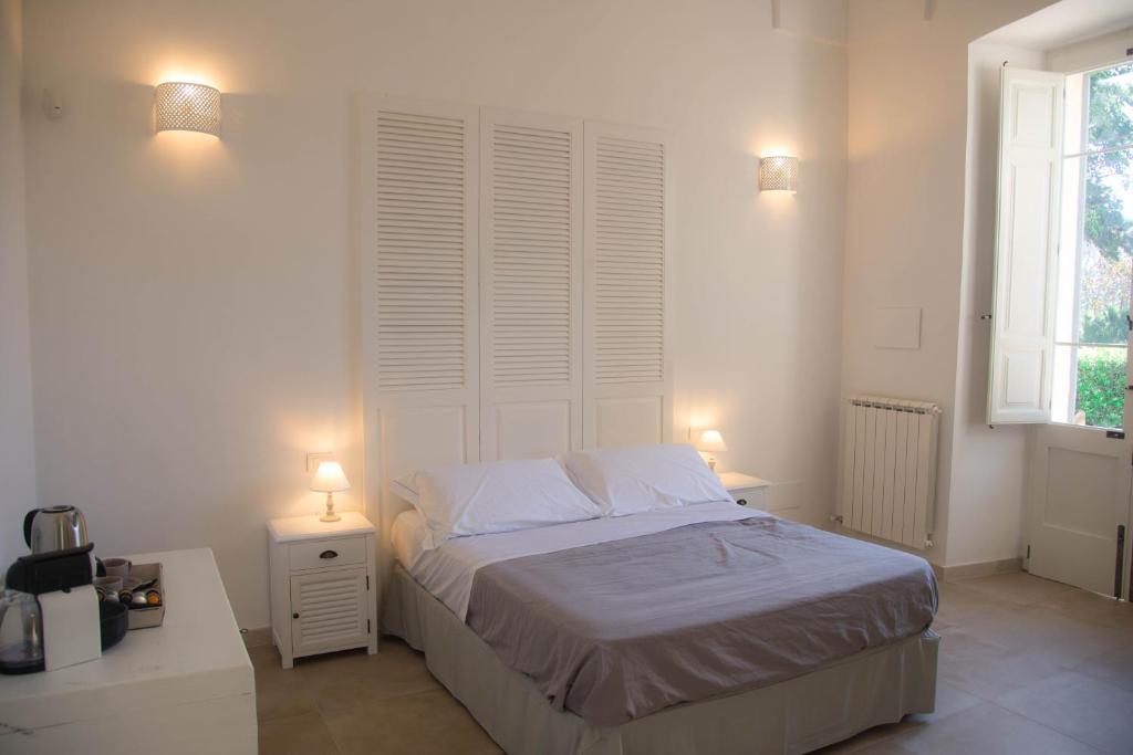 Postel nebo postele na pokoji v ubytování Dimora Del Duca, masseria b&b di charme