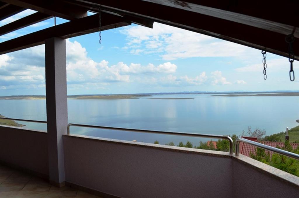 a view of the water from the balcony of a house at Apartments Smokvica I in Smokvica