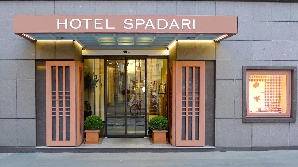 a hotel patagonian entrance to a building with a sign on it at Hotel Spadari Al Duomo in Milan